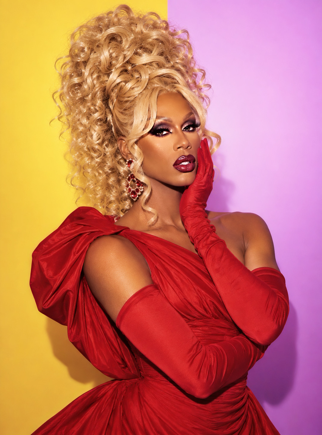Dee Jiles wearing a red gown and gloves in a close RuPaul tribute portrait